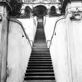 Black and white image of stone steps leading upwards.