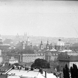 Monochrome cityscape, featuring domes, spires, and rooftops.