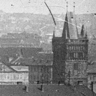 Monochrome cityscape, featuring domes, spires, and rooftops.