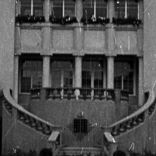 Black and white photo shows a large, historic building.