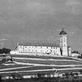 Historic building on a hill overlooking a river.