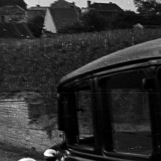 Black and white image of a church and village scene.