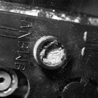 Close-up of a weathered, industrial machine with visible bolts.