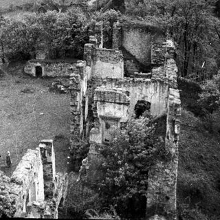 Ruined stone castle remains overlooking a landscape.