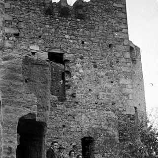Group poses near ruins of a stone structure.