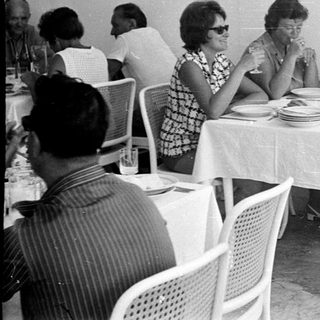 People dining at a table in a vintage restaurant.
