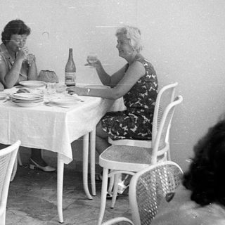People dining at a table in a vintage restaurant.