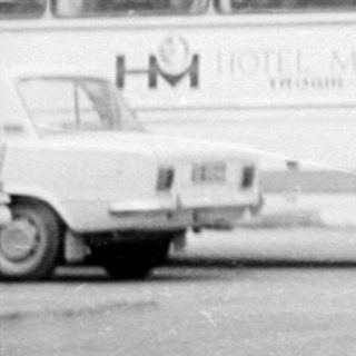 Three women stand in front of a hotel in the 1960s.