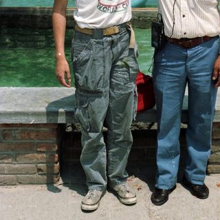Boy and man posing near a water park.