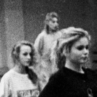 Ballet class in progress; dancers in a gymnasium.