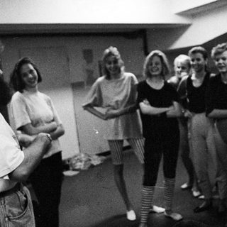 Group of people gathered, possibly in a rehearsal or meeting.