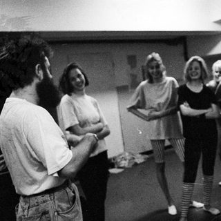 Group of people gathered, possibly in a rehearsal or meeting.