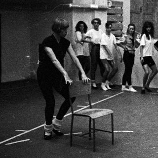 Black and white photo of a dance class in a gym.