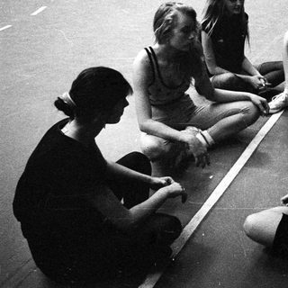 Group of young women sitting and talking on a floor.