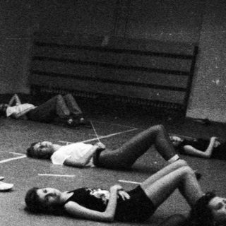 Group of women exercising on a marked floor.