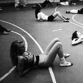 Group of women exercising on a marked floor.
