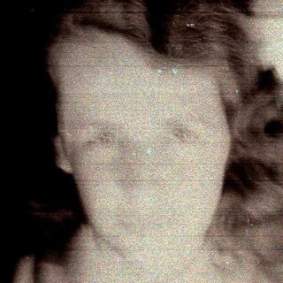 Distorted black and white image of a person's face.