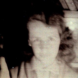 Distorted black and white image of a person's face.