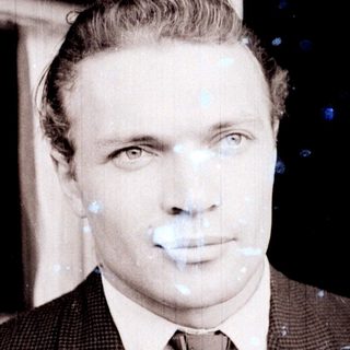 Black and white portrait of a man in a suit.