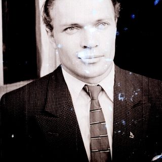 Black and white portrait of a man in a suit.