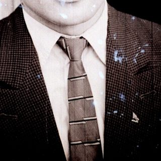 Black and white portrait of a man in a suit.