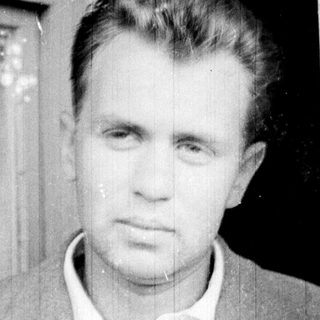 Black and white portrait of a man in a suit.