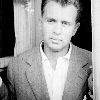 Black and white portrait of a man in a suit.