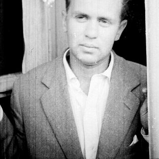 Black and white portrait of a man in a suit.