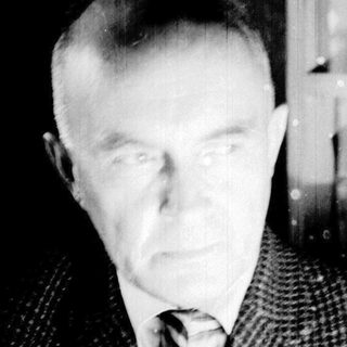 Black and white portrait of a man in a suit.