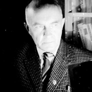 Black and white portrait of a man in a suit.