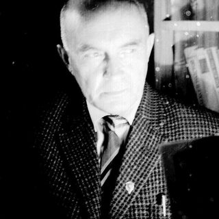 Black and white portrait of a man in a suit.