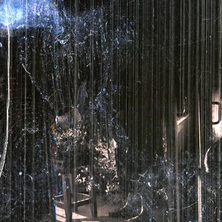 Rain streaks obscure a view of stairs and a doorway.