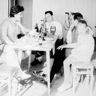 Group of people gathered around a table indoors.