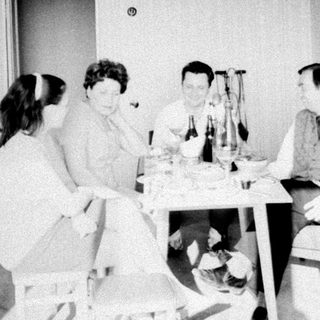 Group of people gathered around a table indoors.