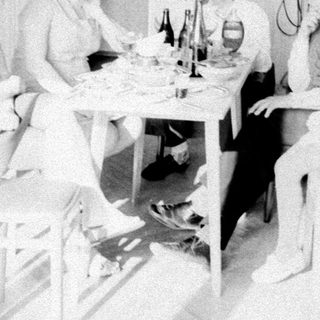 Group of people gathered around a table indoors.
