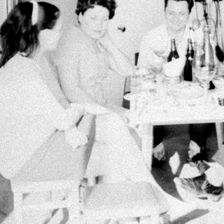 Group of people gathered around a table indoors.