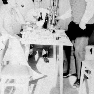 Group gathered around a table, appearing to celebrate or converse.