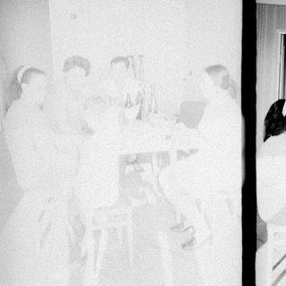 Group gathered around a table, appearing to celebrate or converse.