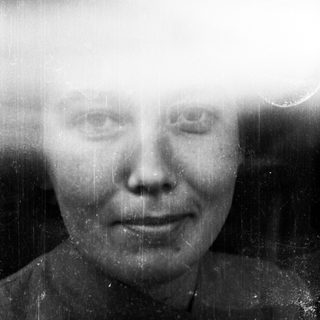 Black and white portrait of a woman with visible film grain.