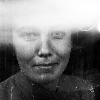 Black and white portrait of a woman with visible film grain.