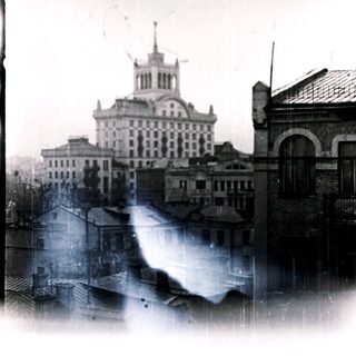 Historic cityscape with buildings and a prominent central structure.
