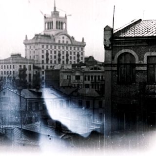 Historic cityscape with buildings and a prominent central structure.