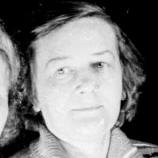 Two women are seated, posed for a black and white portrait.