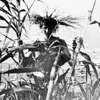 A person stands partially submerged in a body of water.