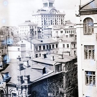 Black and white cityscape with a grand building in the distance.