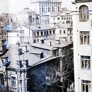 Black and white cityscape with a grand building in the distance.