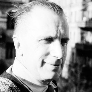 Black and white portrait of a man in a sweater.