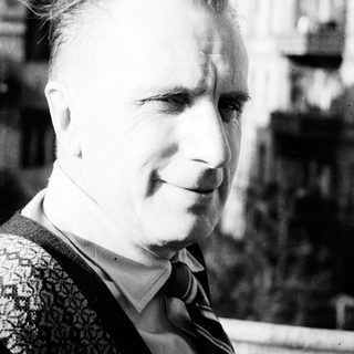 Black and white portrait of a man in a sweater.