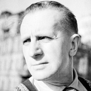 Black and white portrait of a man in a vest.