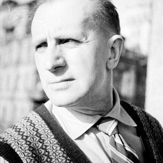 Black and white portrait of a man in a vest.